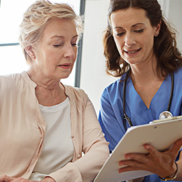 Healthcare professional and patient reviewing information on a clipboard