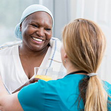 Smiling patient talking to healthcare professional