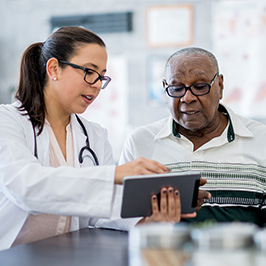 Healthcare professional and patient reviewing results on a tablet