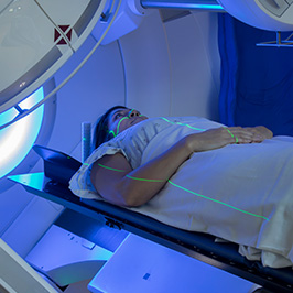 Person lying down inside a radiation therapy machine